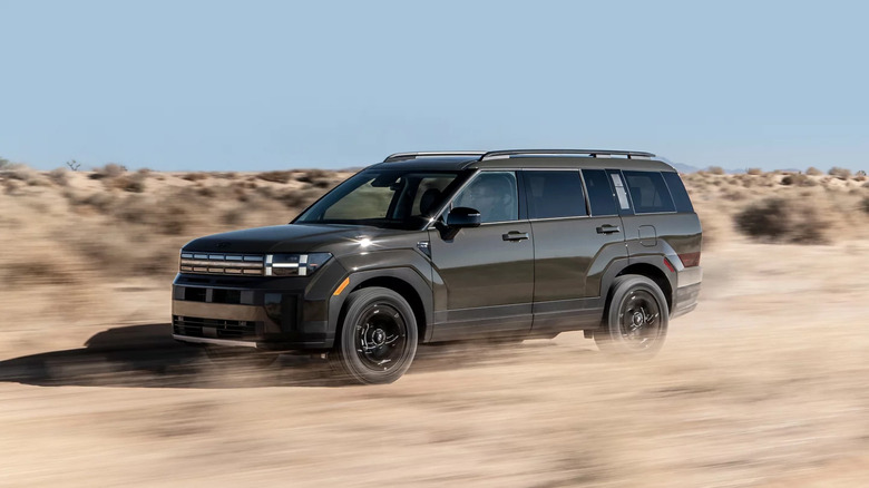 A side on action shot of a 2026 Hyundai Santa Fe XRT driving