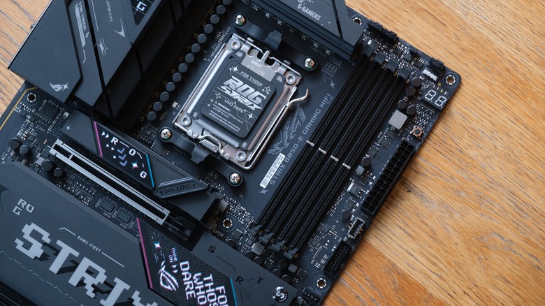 An AM5 motherboard on a wooden table