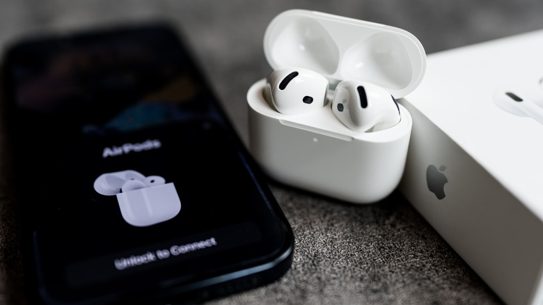 AirPods 4 with icon to connect to iPhone on the screen, when connected first time