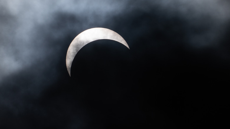 An image of a partial Moon in the sky.