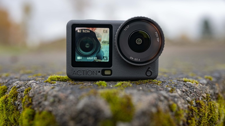 The DJI Osmo Action 6 sitting on a concrete slab with moss.