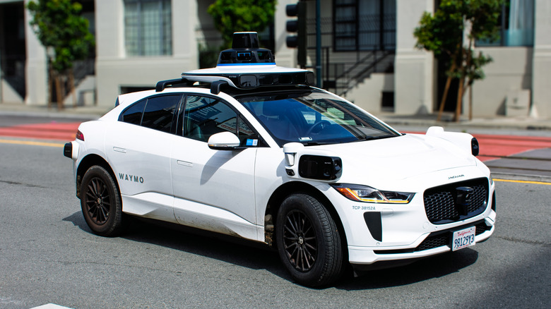 A Waymo car on road.