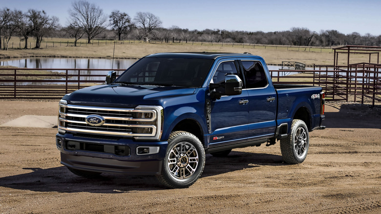 Front left view of blue Ford F-350 parked at ranch