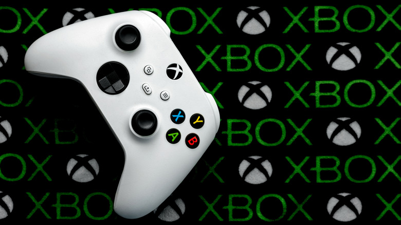 A white Xbox controller on an Xbox branded mat, top view