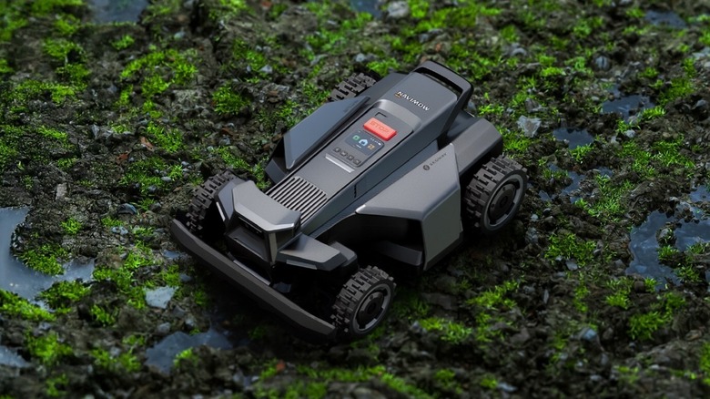 Navimow X4 robot lawn mower on muddy, grassy terrain
