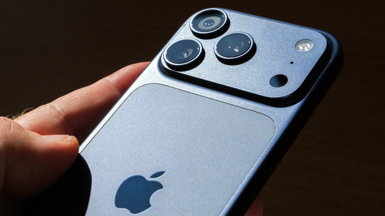 hand holding the Apple iPhone 17 Pro Max in blue