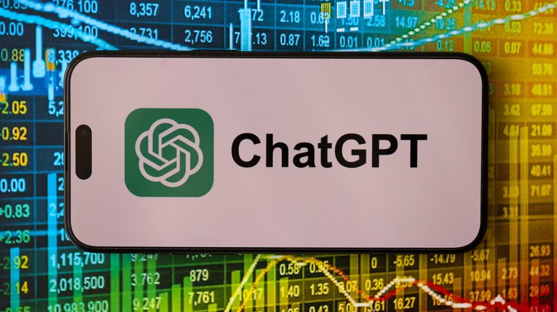 Smartphone showing the ChatGPT logo in from of a brightly colored screen showing stock market info