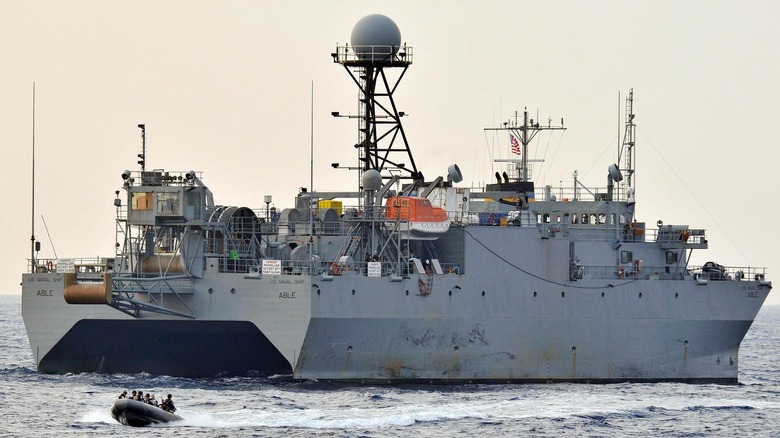 Sailors assigned to the visit, board, search and seizure (VBSS) team of the guided-missile destroyer USS Mustin (DDG 89) depart the Military Sealift Command ocean surveillance ship USNS Able (T-AGOS 20) after completing a VBSS drill.