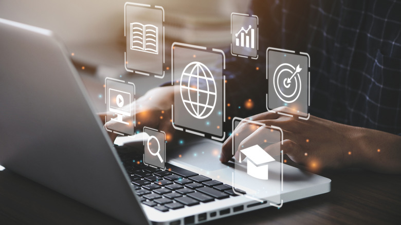 Person typing on laptop with digital overlay of generic app icons