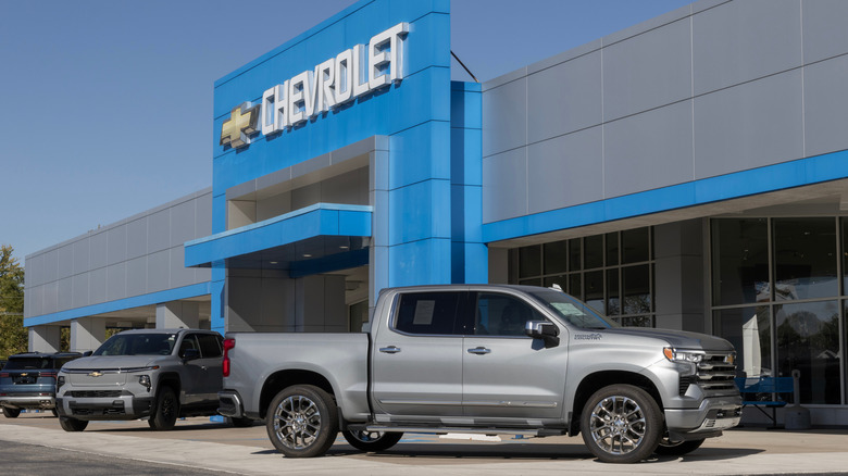 Chevy trucks parked in front of showroom