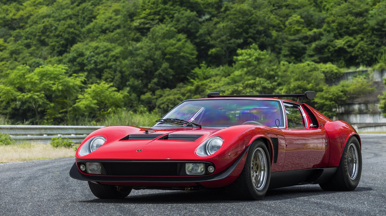 1974 Lamborghini Miura SVR parked in front of green woodlands, front-left 3/4 view