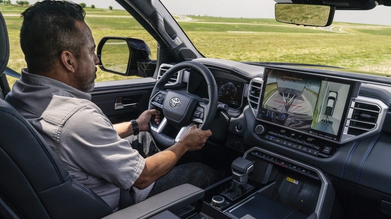 Person driving a Toyota Tundra on a dirt road